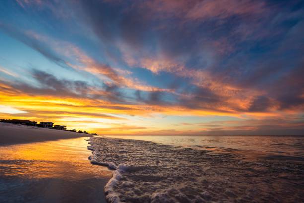 istock Sunset over tranquil beach with vibrant sky. 2188238551