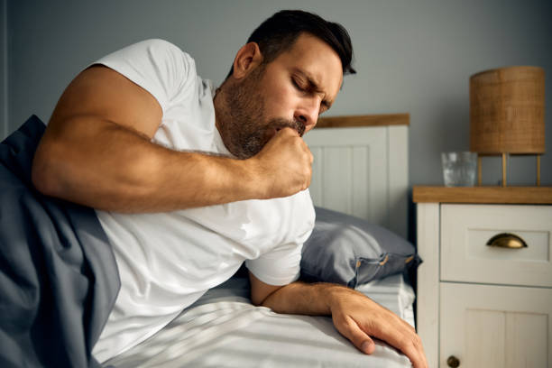 istock Ill man coughing after waking up in the morning. 2188240194