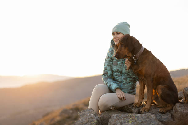 istock Woman with her dog taking a break from hiking 2188241206