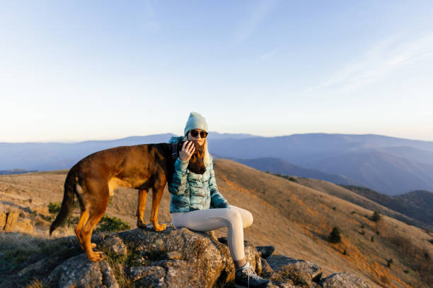 istock Woman with her dog taking a break from hiking 2188241210