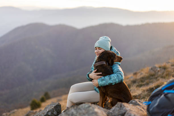 istock Woman with her dog taking a break from hiking 2188241217