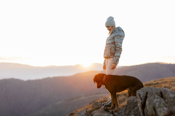 istock Woman with her dog taking a break from hiking 2188241245