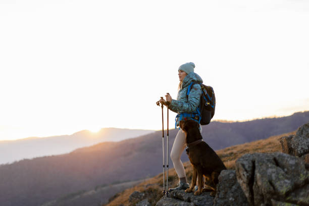 istock Woman with her dog taking a break from hiking 2188241246