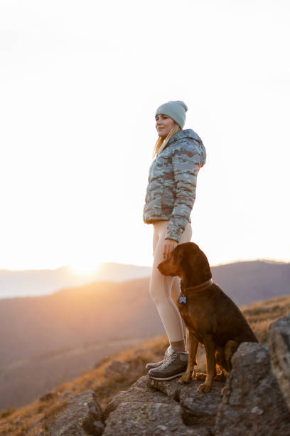 istock Woman with her dog taking a break from hiking 2188241256