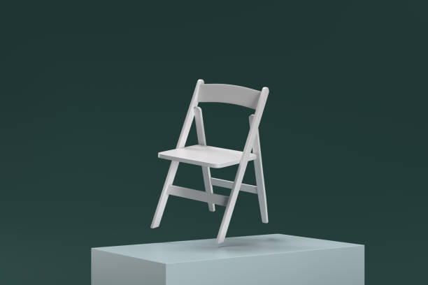 istock A white folding chair is suspended in midair on a green surface 2188245290