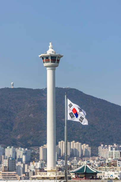 the busan tower with national flag in the wind, busan city, south korea.