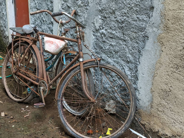 istock Two rusted bicycles leaning against a weathered wall, capturing a nostalgic scene of bygone days. 2188247515
