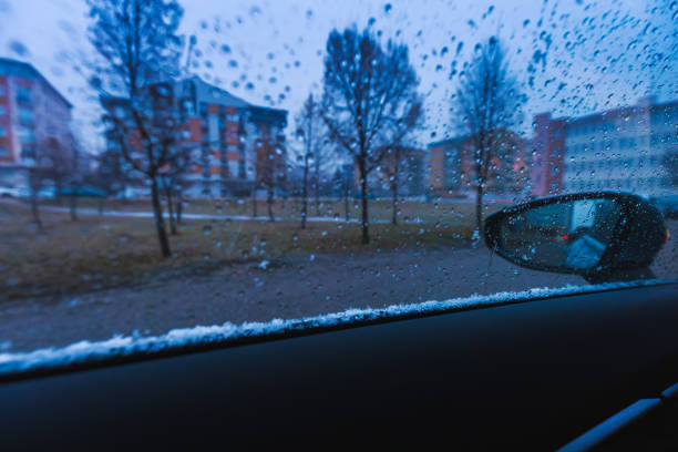 On a winter morning drive to work before the dawn breaks, sitting inside the car , accompanied by the silent snowfall