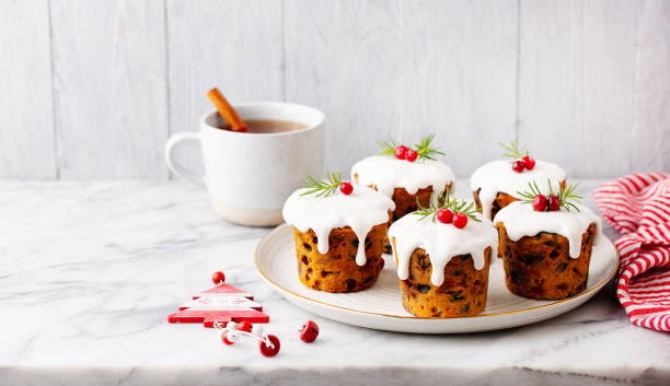 istock Christmas pudding, cakes with tea. Traditional dessert. Marble table. Grey background. Close up. Copy space. 2188248913