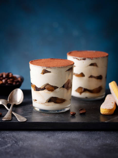 istock Tiramisu dessert in glass on marble cutting board. Blue background. Copy space. 2188249121