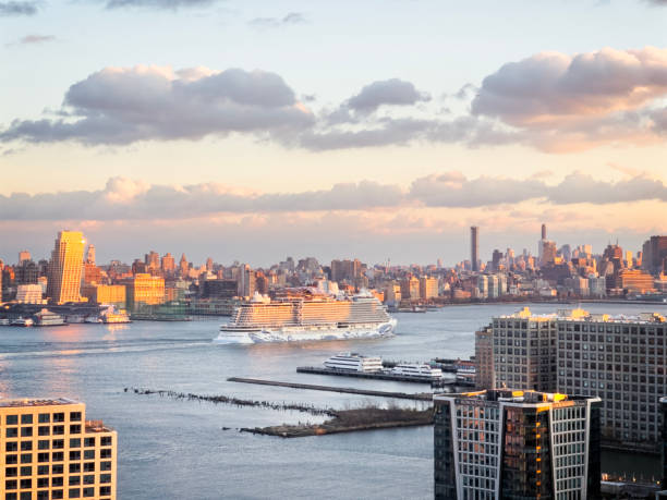 New York City, NY, USA - Nov 30 2024: Huge cruise ship leaving the city in front of Manhattan view in New York City