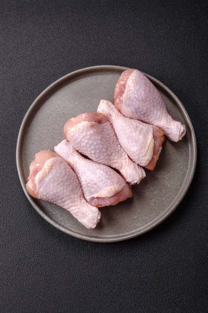 istock Raw chicken legs with salt, spices and herbs 2188255826
