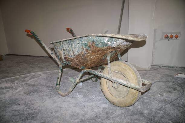 istock Rusty Wheelbarrow on a dirty indoor Construction Site 2188255912