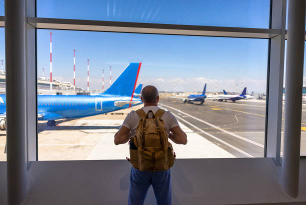 istock Rear view of backpacker on airport 2188256048
