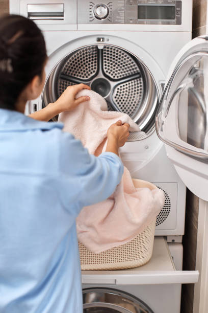 istock woman put pastel cotton towel in automatic washing machine 2188256628