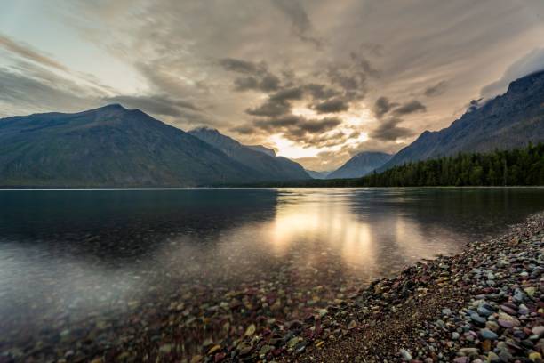 istock Serene mountain lake at sunset with dramatic clouds. 2188257729