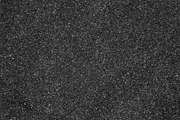 istock Black sand beach texture as background, top view. Volcanic sand background. 2188259213