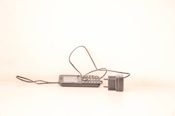 istock Small black cell phone and charger 2188262472