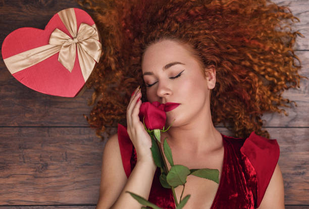 istock Beautiful Young Woman With a Red Rose 2188270909
