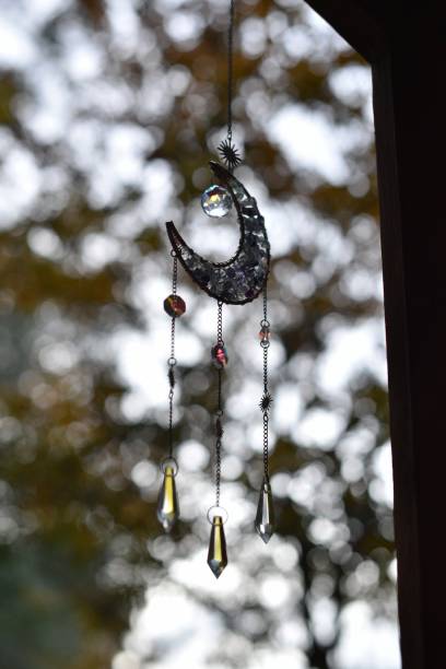 istock Crystal Moon Catcher Hanging In Front Of Trees 2188275465
