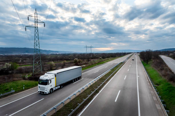 istock White transportation truck on a highway 2188277086
