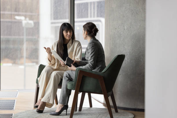 istock Two businesswomen colleagues use tablet discuss project seated on armchairs 2188278718
