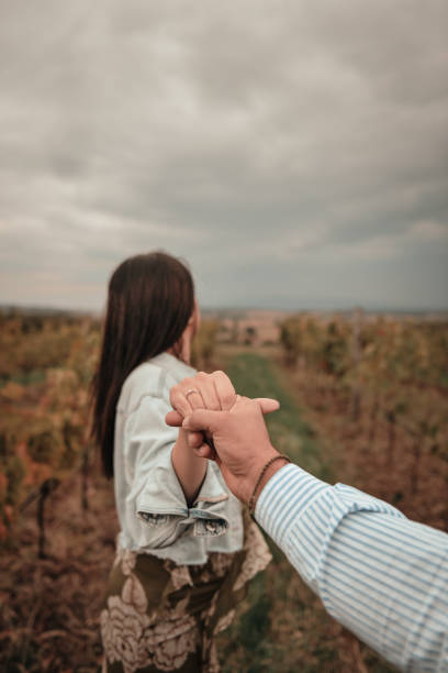 Close-up of a loving mature couple holding hands together during a day outdoors in the countryside