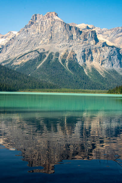 The mountains reflected in beautiful Emerald Lake in Yoho National Park, Alberta, Canada.