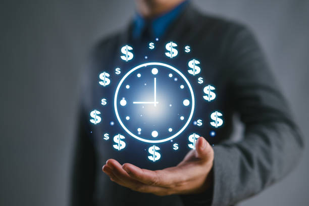 istock Time management concept, businessman holding clock and money icon on interface virtual for business time management. time is money, work planning increases efficiency and reduces work time. 2188286510