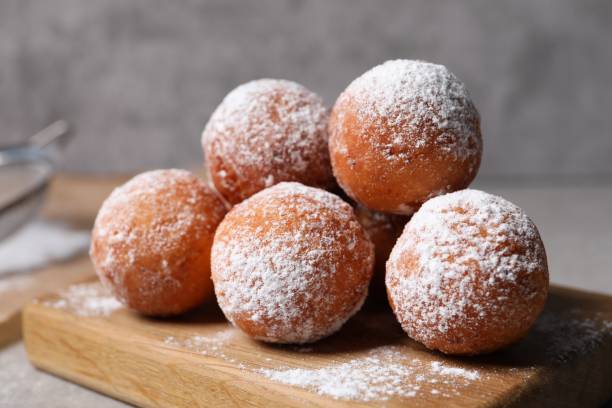 istock Delicious sweet buns with powdered sugar on table, closeup 2188286621