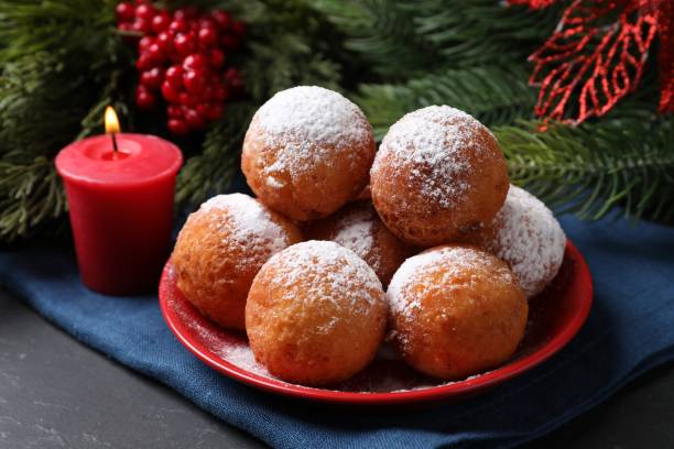 istock Delicious sweet buns, fir tree branches and burning candle on table, closeup 2188286646