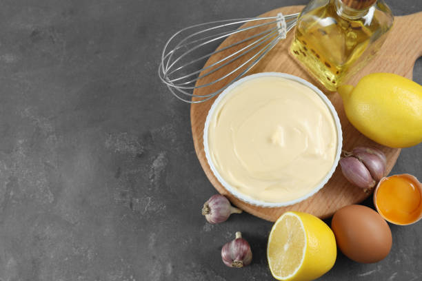 istock Fresh mayonnaise sauce in bowl and ingredients on grey table, flat lay. Space for text 2188287013