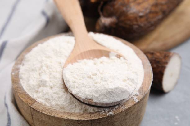 istock Wooden bowl and spoon with cassava flour on grey table, closeup 2188287543