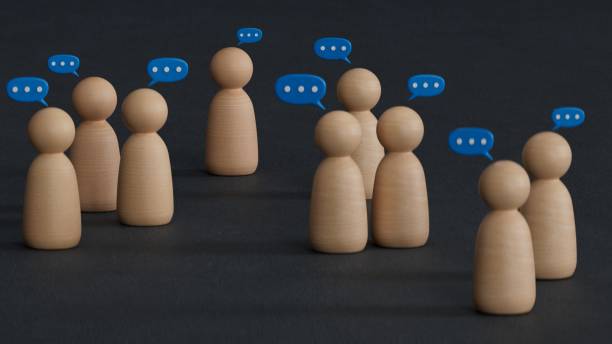 istock Team discussion, Community or social feedback. Communication or announcement dialog. Business meeting. Teamwork and communication concept. Many wooden figure with speech bubble. 2188290971