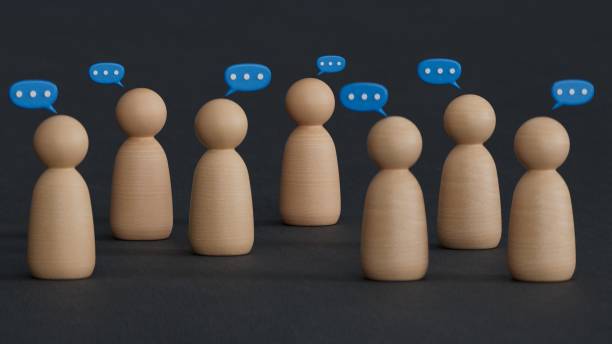 istock Social gathering with texting bubbles message communication on wooden figurine and table top. People lifestyles and social media concept.3D rendering on black background. 2188291182