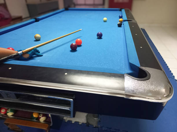 istock Young man playing billiard in a pool hall. 2188298600