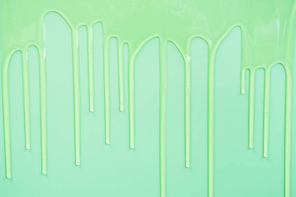 istock liquid shampoo dripping down on green background close-up. 2188299818