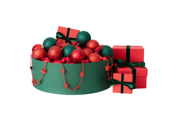 A green box with red Christmas decorations and gift boxes isolated on white background. New Year decor.