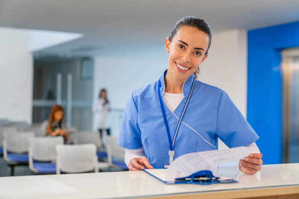 istock Nurse checking a form at the reception desk in the hospital 2188301867