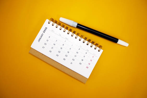 istock January 2025 desk calendar with pen on yellow background 2188302776