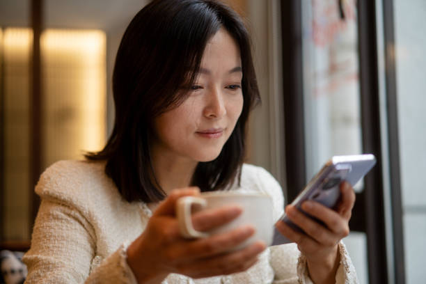 istock asian female using smart phone in coffee shop 2188309232