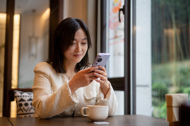 istock asian female using smart phone in coffee shop 2188309245