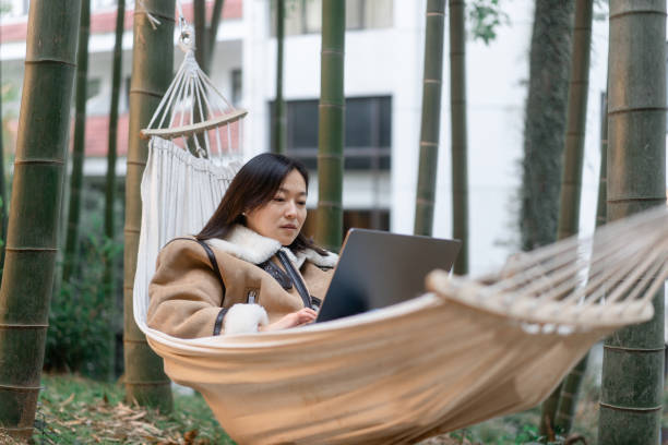 istock Women are using laptop on the hammock. 2188310194