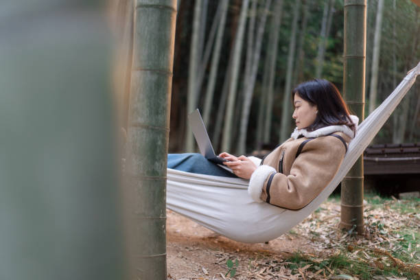 istock Women are using laptop on the hammock. 2188310218