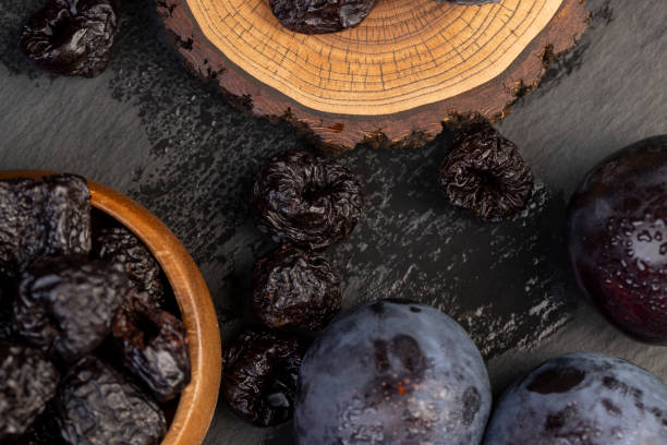 istock ripe purple plums and dried plums 2188311590