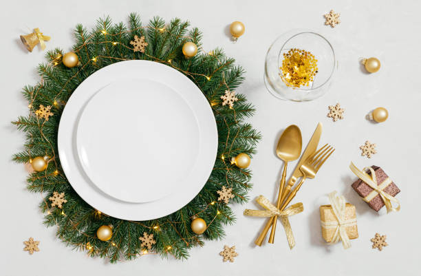 istock Empty white plate with Christmas golden decorations on white background. New Year table setting. Directly above. Flat lay. Template for menu or design. 2188314312