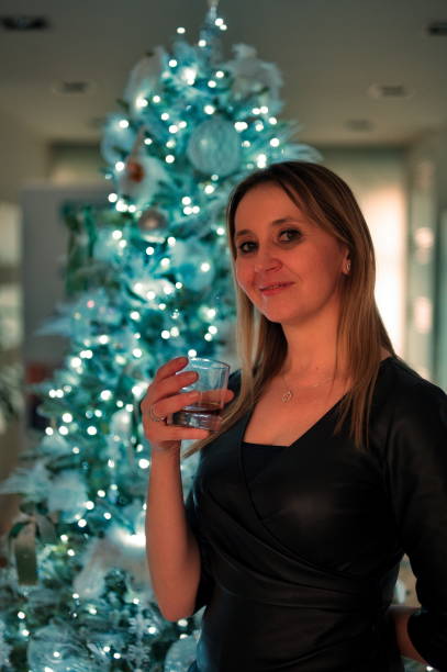 istock Woman in front of Christmas tree 2188316405