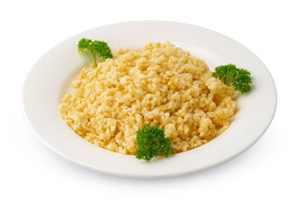 Cooked rice in a white plate on white background, close up