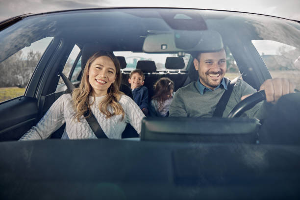 istock Happy family enjoying while going on a vacation by car. 2188318293