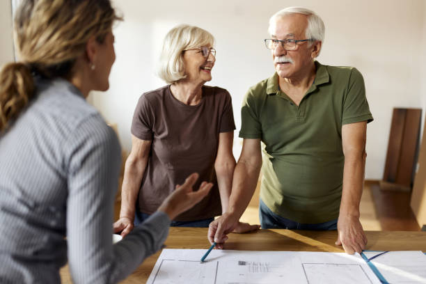 istock Happy senior couple talking about blueprints with their architect. 2188318507